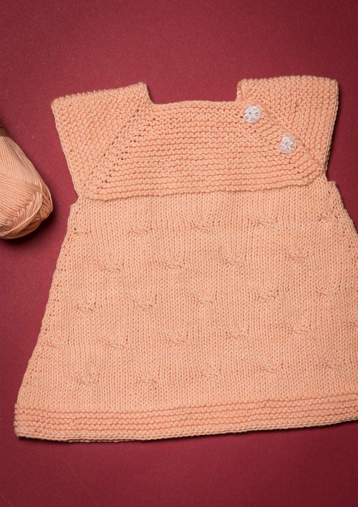 Strikket tunika til baby
